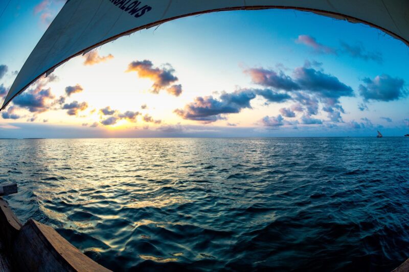 Sail Away, Nungwi, Zanzibar – traditional dhow sail framing the calm Indian Ocean at sunset